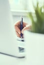 Businessman hand writing note on a notebook. Business man working at office desk. Close up of empty notebook on a Royalty Free Stock Photo