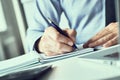 Businessman hand writing note on a notebook. Business man working at office desk. Close up of empty notebook on a Royalty Free Stock Photo