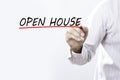 Businessman hand writing OPEN HOUSE with red marker on transparent wipe board, business concept Royalty Free Stock Photo