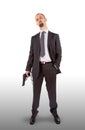 Businessman in handcuffs with pistol in hand Royalty Free Stock Photo