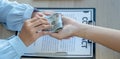 A businessman handed bribe money to the officials to sign a business agreement concept about corruption and anti-bribery