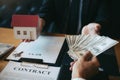 Businessman handed the money new home and real estate trading concepts