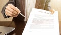 Businessman handing over a contract for signature offering a ballpoint pen Royalty Free Stock Photo