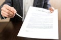 Businessman handing over a contract for signature offering a ballpoint pen in his hand Royalty Free Stock Photo