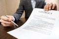 Businessman handing over a contract for signature offering a pen in his hand Royalty Free Stock Photo