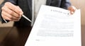 Businessman handing over a contract for signature offering a pen in his hand Royalty Free Stock Photo