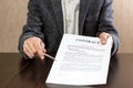 Businessman handing over a contract for signature offering a pen in his hand Royalty Free Stock Photo