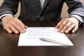 Businessman handing over a contract for signature offering a ballpoint pen Royalty Free Stock Photo