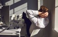 Businessman resting relaxes meditating dreams at the workplace at the table with a computer in office Royalty Free Stock Photo