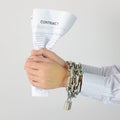 Businessman hands with chains and contract Royalty Free Stock Photo