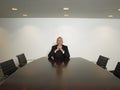 Businessman With Hands Clasped Sitting In Conference Room Royalty Free Stock Photo