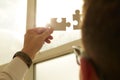 Businessman hands connecting puzzle pieces representing the merging of two companies or joint venture, partnership Royalty Free Stock Photo