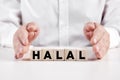 Businessman hands covers the wooden cubes with the word halal Royalty Free Stock Photo