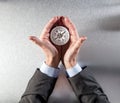 Businessman hands displaying a compass in his palms for idea