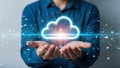 Businessman hands holding glowing virtual cloud icon on dark background cloud computing and data storage concept Royalty Free Stock Photo