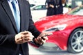 Businessman hands holding trade booking using smart phone with blurred background