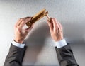 Businessman hands holding wooden rattle for office wake-up call