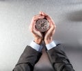 Businessman hands protecting a compass, leading the company perspective