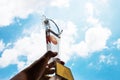 Champion hands raised and holding light trophy, show successful about sport basketball against blue sky background. Concept of Wi Royalty Free Stock Photo