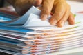 Businessman hands searching unfinished documents stacks of paper files on office desk for report papers, piles of sheet achieves Royalty Free Stock Photo