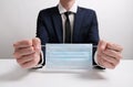 Businessman Hands with Surgical Mask Bound Like Handcuffs