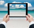 Businessman hands tablet taking pictures beach and sea