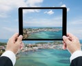 Businessman hands tablet taking pictures beach and sea