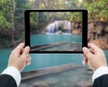 Businessman hands tablet taking pictures Waterfall deep forest Royalty Free Stock Photo