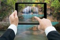 Businessman hands tablet taking pictures Waterfall deep forest Royalty Free Stock Photo