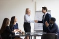 Businessman handshake female employee greeting with promotion