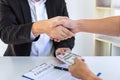 Businessman handshake with money of dollar banknotes in hands from money of their partner to give success the deal contract in a Royalty Free Stock Photo