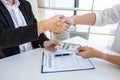 Businessman handshake with money of dollar banknotes in hands from money of their partner to give success the deal contract in a Royalty Free Stock Photo