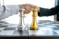 Businessman handshake near the chess board silver and gold