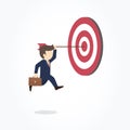 Businessman hanging arrow on target. Goal achievement concept.