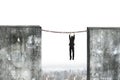 Businessman hanging rusty chain connected concrete walls