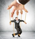 Businessman hanging on strings like marionette Royalty Free Stock Photo