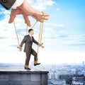 Businessman hanging on strings like marionette Royalty Free Stock Photo