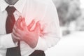 Businessman having chest pain while work heart attack outdoor. or Hard work not enough rest causes the body to shock heart disease