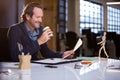 Businessman having coffee while reading document