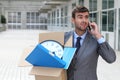 Businessman having a dramatic moment on the phone after being fired Royalty Free Stock Photo