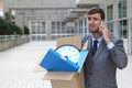 Businessman having a dramatic moment on the phone after being fired Royalty Free Stock Photo