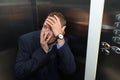 Businessman having panic attack in elevator Royalty Free Stock Photo