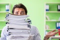 The businessman having problems with paperwork and workload Royalty Free Stock Photo