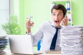 The businessman having problems with paperwork and workload Royalty Free Stock Photo