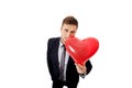 Businessman with heart shaped balloon.