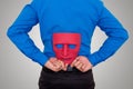 Businessman hide mask behind his back.