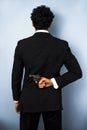 Businessman hiding gun behind his back