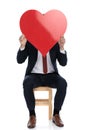 Businessman hiding his face behind a big red heart Royalty Free Stock Photo