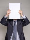 Businessman hiding his face with a white paper Royalty Free Stock Photo