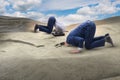 The businessman hiding his head in sand escaping from problems Royalty Free Stock Photo